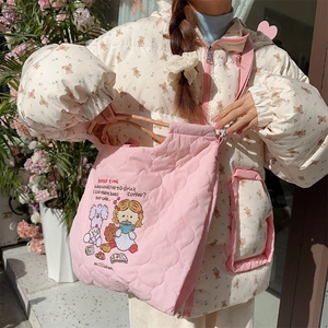 Detailed close-up of pink quilted tote bag with cute embroidery and cotton padding