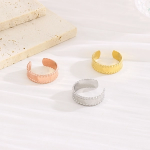 Detailed view of three adjustable 18k gold plated steel rings with beaded edge design