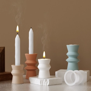 Detailed view of wave-shaped cylinder resin molds and DIY finished candle holders