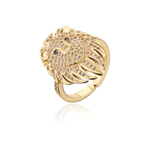 Detailed view of gold lion head ring with sparkling zircons and blue gemstone eyes