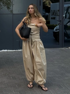 Detail of khaki cotton two-piece set featuring pleated bandeau top and baggy harem pants