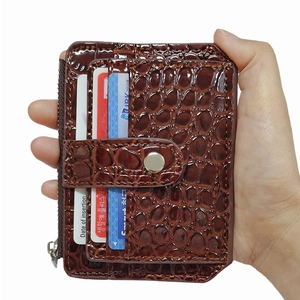 Dark brown crocodile pattern leather card holder with snap closure and zipper pocket