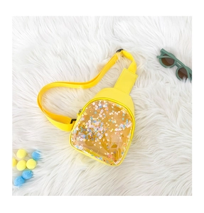 Detail of yellow PVC kids chest bag with colorful sequins and star-shaped glitter