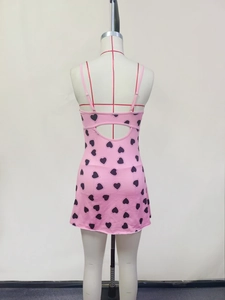Detailed back view of pink heart print dress with cut-out design and slim fit straps