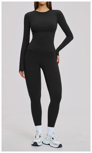 Front view of black long-sleeve yoga set with high-waisted leggings on a model