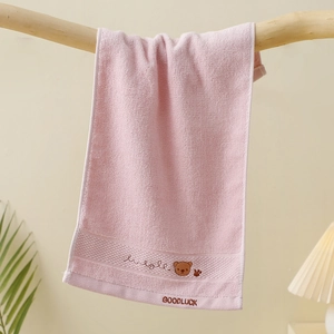 Detail of pink cotton kids towel with cute bear embroidery and Goodluck text