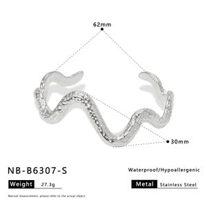 Detail view of silver wave-shaped stainless steel bracelet with waterproof texture specs