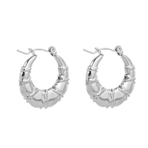 Detailed view of silver hoop earrings with polished segmented bamboo texture design