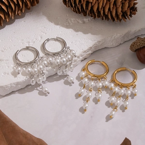Golden and silver stainless steel hoop earrings with elegant white pearl tassels