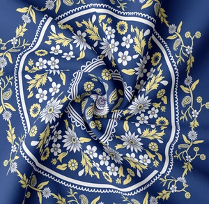 Detail of floral paisley pattern on thick dark blue woven fabric with textured folds