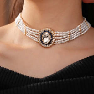 Detail of multi-layer pearl choker with blue enamel oval crystal pendant on model