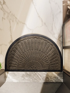 Close-up of semi-circle door mat with sunburst texture and non-slip rubber border