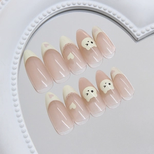 Cute cream French press-on nails with cartoon bear heart patterns and nude pink base