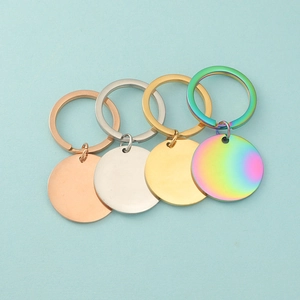 Flat lay of four mirrored stainless steel keychains in rose gold, silver, gold, and rainbow