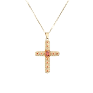 Detailed macro view of 18K gold-plated cross necklace with orange zircon gemstones