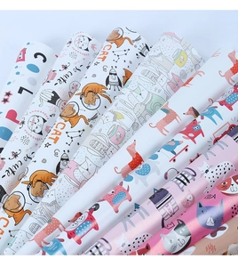 Close-up of vibrant cartoon cat and dog gift wrapping paper rolls in various patterns