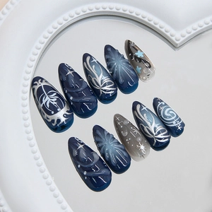 Dark blue and grey almond press-on nails with 3D silver star and spiral patterns