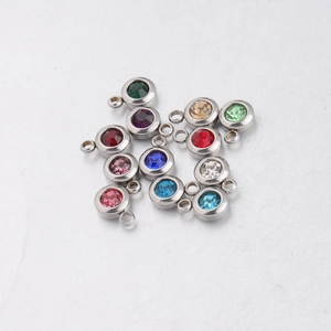 Detailed macro view of 12-color round stainless steel birthstone charms for DIY jewelry