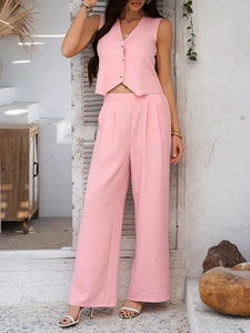 Detail of pink two-piece vest and wide-leg pants set with crinkled fabric texture