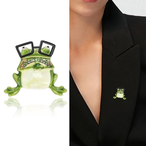 Cute green enamel frog brooch wearing black glasses with rhinestones on black suit lapel