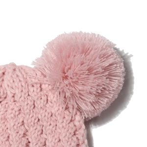 Detailed close-up of pink knit hat featuring soft texture and large fluffy pom-pom