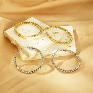 Twisted rope hoop earrings in 18K gold and silver plating on stone pedestals