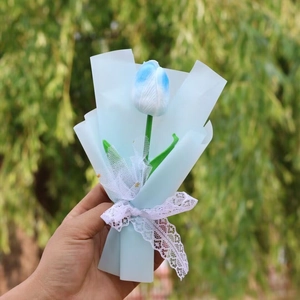 Detail of blue and white gradient artificial tulip bouquet with white lace ribbon bow