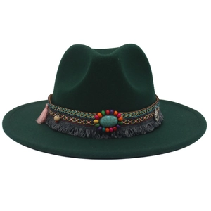 Detail of dark green cowboy hat with bohemian ribbon, fringe and large turquoise stone