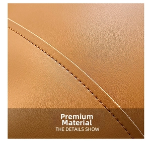 Close-up of brown litchi grain leather texture with precise stitching on bucket bag