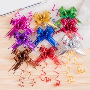 Close-up of vibrant matte and metallic gift pull bows on a rustic wooden background