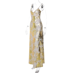 Detailed view of backless gold and white dress with metallic texture and deep V-neck
