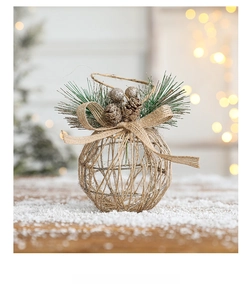 Detail of Christmas iron hollow ball ornament with pine cones, berries and burlap bow