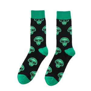 Detail shot of black knitted crew socks featuring green alien patterns and contrast heels