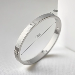 Detailed macro view of 6mm silver wave engraved bangle with secure hinge mechanism