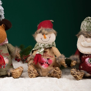 Christmas gift bags with snowman and reindeer plush figures and Merry Christmas embroidery