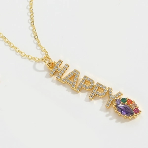 Detail showing gold HAPPY letter pendant with colorful gemstones on a delicate chain