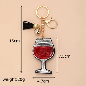 Detailed view of rhinestone wine glass keychain with black leather tassel and gold ring