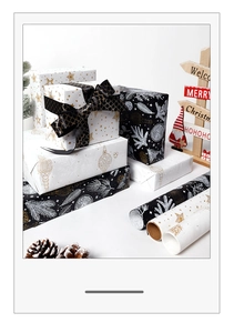 Close-up of Christmas kraft wrapping paper with gold stars and silver floral patterns