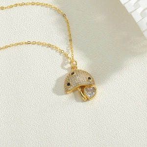 Elegant gold mushroom pendant necklace with white zircons and heart-shaped crystal drop
