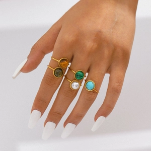 Five vintage 18K gold plated stainless steel rings with colorful natural stones on model hand
