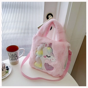 Detail of pink plush unicorn handbag with rainbow mane and sparkly purple heart embroidery