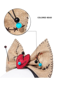 Detail of Voodoo doll headband featuring burlap texture, heart patch and colored beads