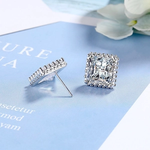 Detailed close-up of square zircon stud earring with intricate silver micro-bead setting
