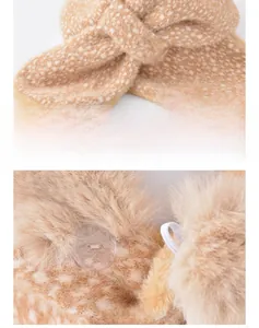Detail of plush faux fur scarf featuring deer spots and transparent resin button closure