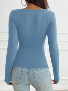 Back view of a slim fit blue long sleeve T-shirt paired with light jeans