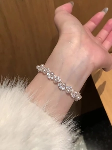 Detailed close-up of a pearl and zircon bracelet showing elegant layered design on wrist