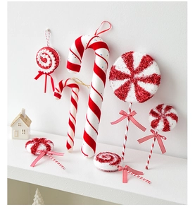 Macro detail of red and white candy cane ornaments with glitter texture and ribbons