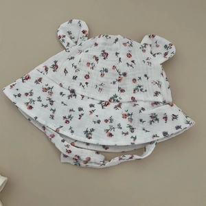 Detail of floral baby sun hat with cute ears and breathable cotton muslin texture