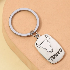 Silver metal Taurus zodiac keychain with embossed bull head and Touro lettering