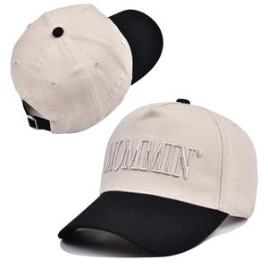 Close-up of MOMMIN embroidery and adjustable metal buckle on contrast baseball cap